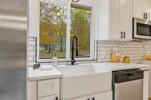 19 Mckinley Ln, Albrightsville, PA 18210 - kitchen with stainless steel appliances, a sink, tasteful backsplash, white cabinetry, and light countertops