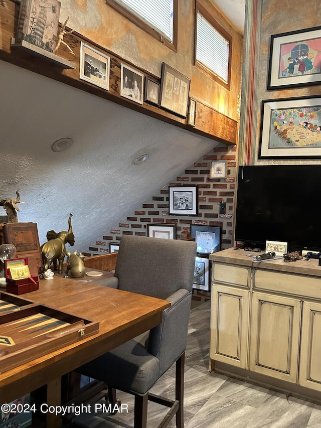 office featuring lofted ceiling and light wood-type flooring