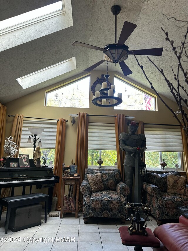 living room with vaulted ceiling, a textured ceiling, and tile patterned floors