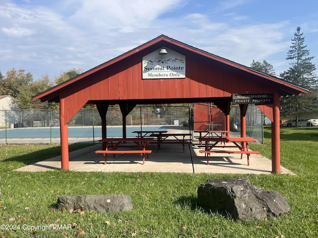 view of community with a yard, fence, and a gazebo