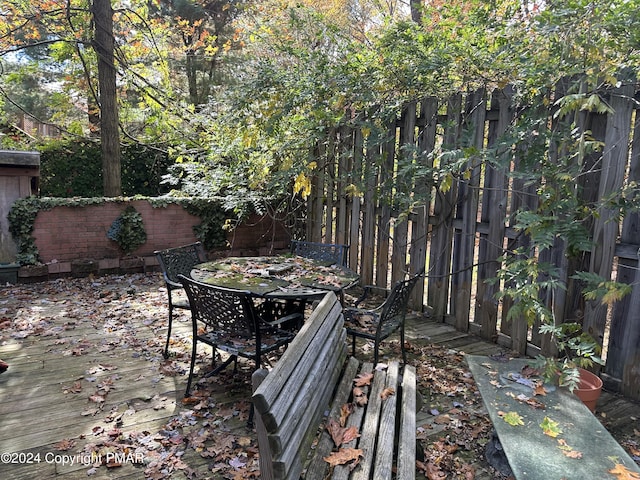 deck featuring a fenced backyard and outdoor dining space