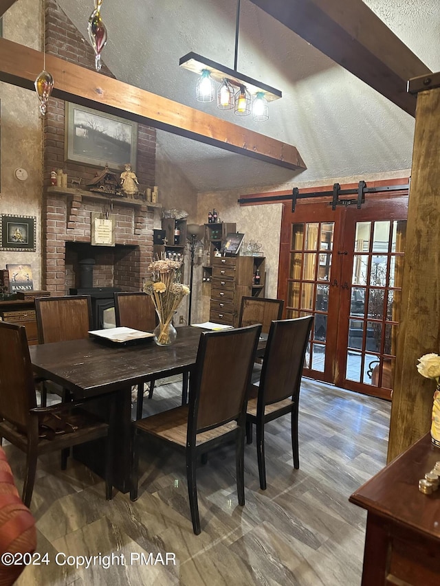 dining space with vaulted ceiling and a textured ceiling