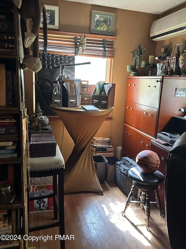 interior space featuring an AC wall unit and wood-type flooring