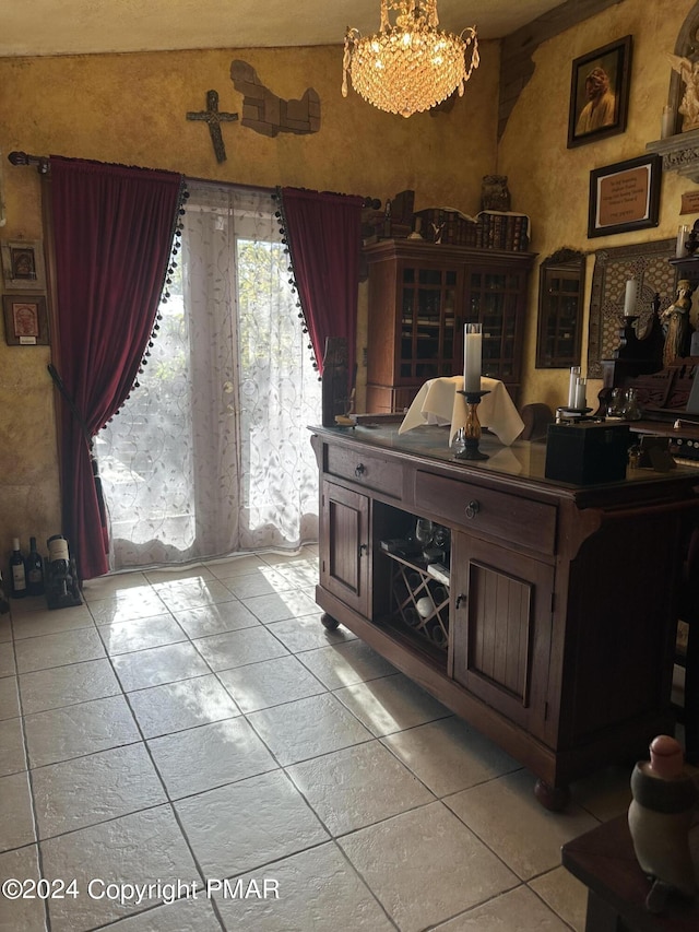 dining room with a notable chandelier and light tile patterned floors