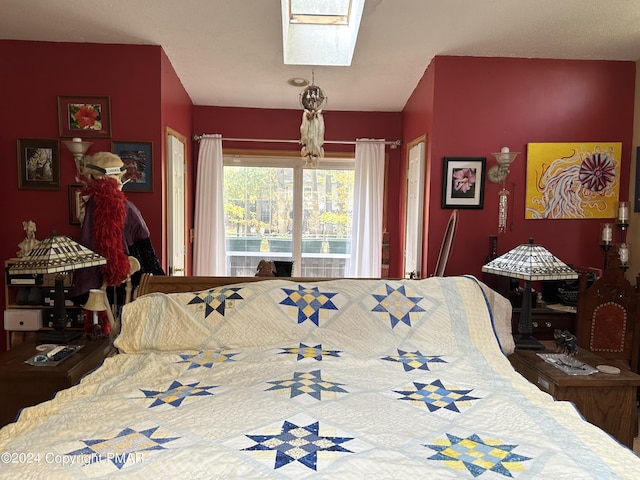 bedroom with a skylight and access to outside