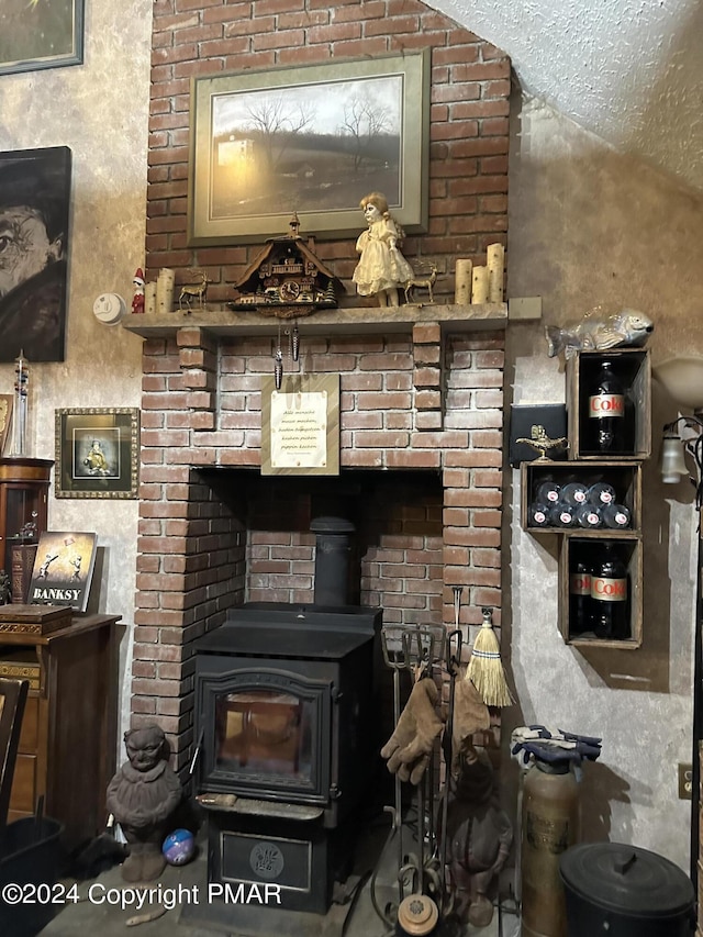 interior details with a wood stove and a textured ceiling