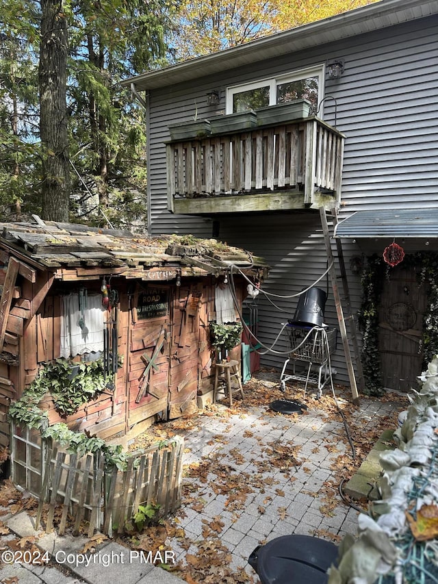 back of property featuring a balcony