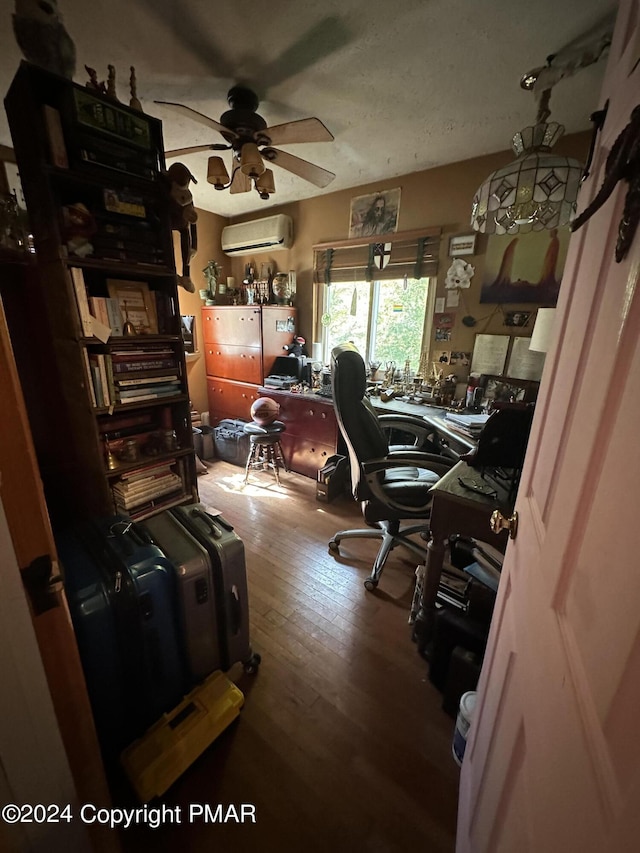 office with a wall mounted air conditioner, ceiling fan, and hardwood / wood-style flooring