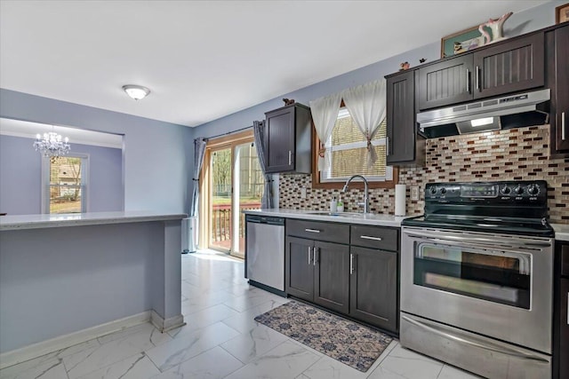 190 Reunion Rdg, East Stroudsburg, PA 18301 - kitchen featuring appliances with stainless steel finishes, an inviting chandelier, a sink, decorative backsplash, and under cabinet range hood