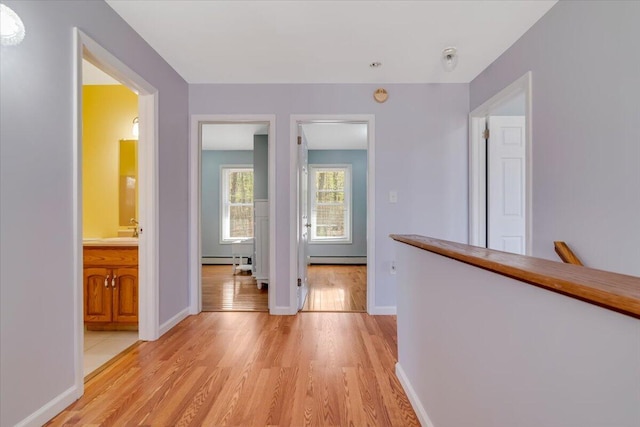 190 Reunion Rdg, East Stroudsburg, PA 18301 - hall featuring baseboards, a baseboard heating unit, a sink, and light wood-style floors