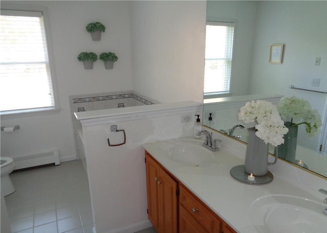 144 Dogwood Dr, Jim Thorpe, PA 18229 - bathroom featuring a baseboard radiator, double vanity, toilet, a garden tub, and tile patterned floors