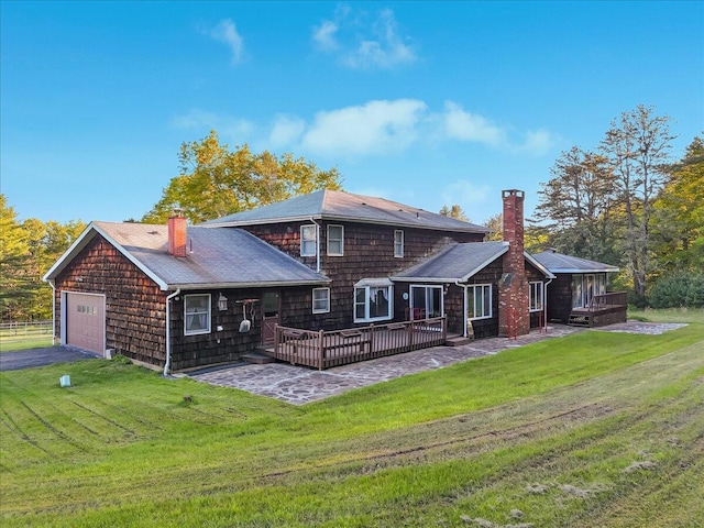 1163 Bush Rd, Cresco, PA 18326 - back of house with a chimney, a wooden deck, a yard, asphalt driveway, and roof with shingles