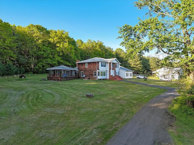 1163 Bush Rd, Cresco, PA 18326 - view of home's exterior with a lawn, asphalt driveway, and a chimney