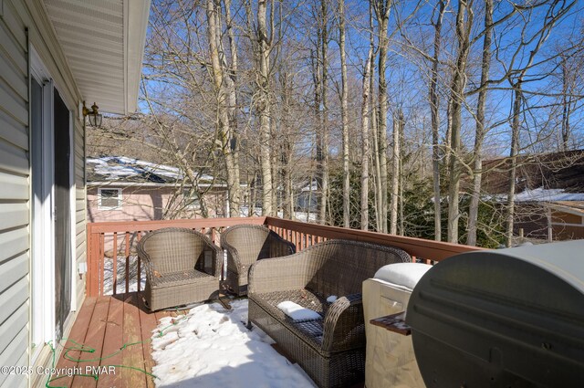 snow covered deck with area for grilling