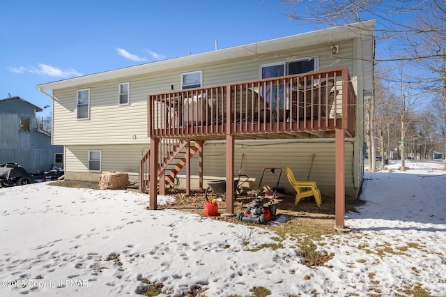 snow covered property with a wooden deck