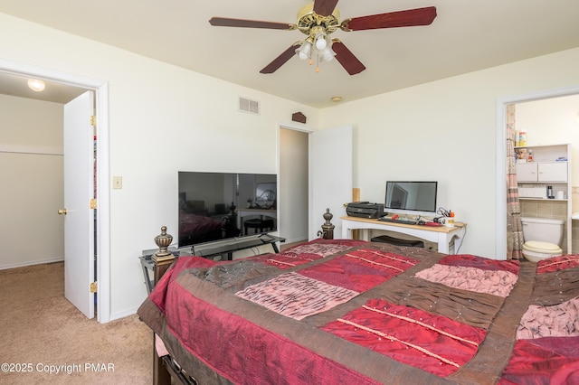 carpeted bedroom featuring ceiling fan and ensuite bathroom