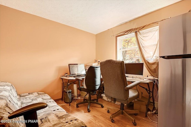 office area with a textured ceiling and wood finished floors