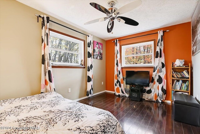 bedroom featuring a textured ceiling, wood finish floors, a ceiling fan, and baseboards