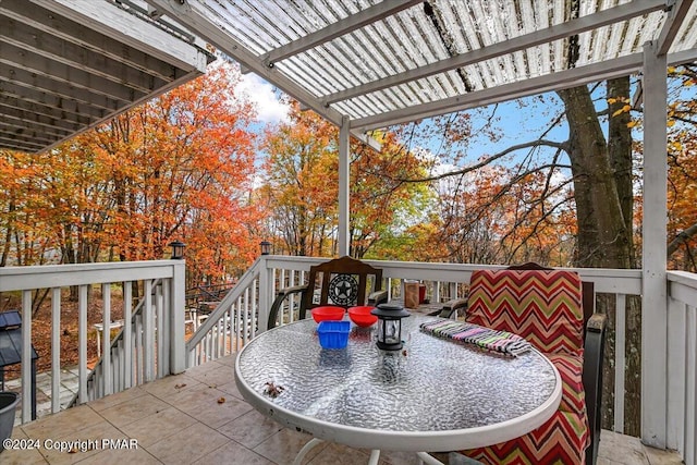 deck with outdoor dining space and a pergola