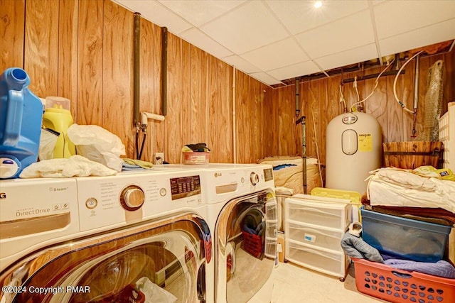 laundry area featuring laundry area, washer / dryer, and wooden walls