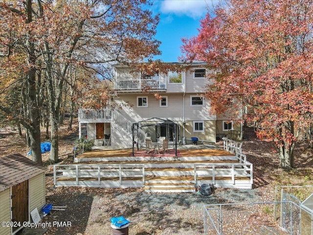 back of house with fence, a patio, and stairs