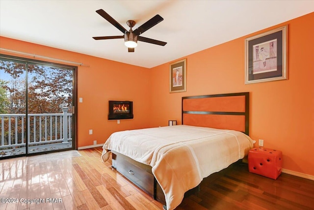 bedroom with access to outside, ceiling fan, baseboards, and wood finished floors