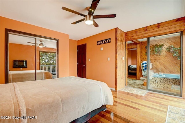 bedroom featuring access to exterior, ceiling fan, baseboards, and wood finished floors