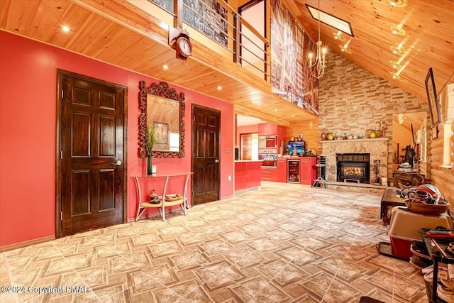 interior space with high vaulted ceiling, a fireplace, and wood ceiling