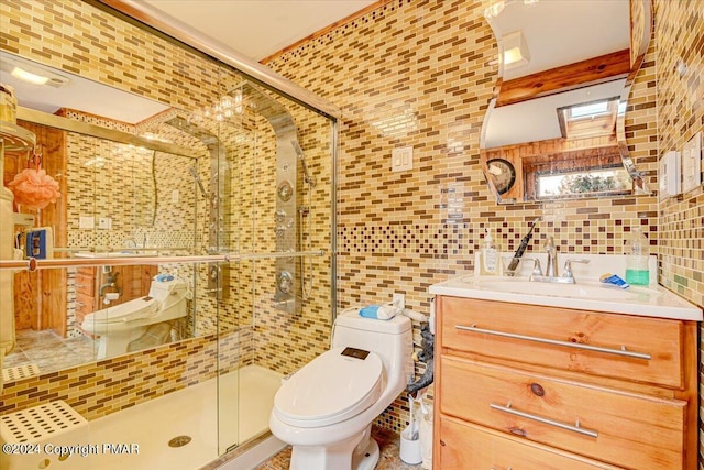 bathroom featuring a stall shower, tile walls, toilet, and vanity