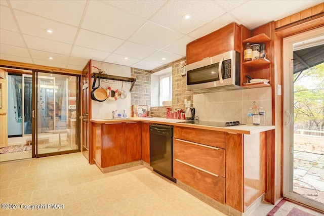 kitchen with black appliances, open shelves, and light countertops