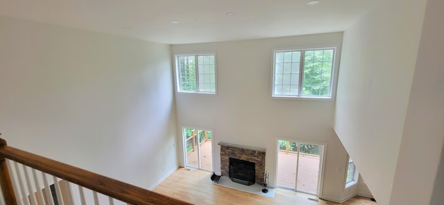 259 Great Bear Way E, Stroudsburg, PA 18302 - living room with light wood-style floors, a fireplace, and a towering ceiling