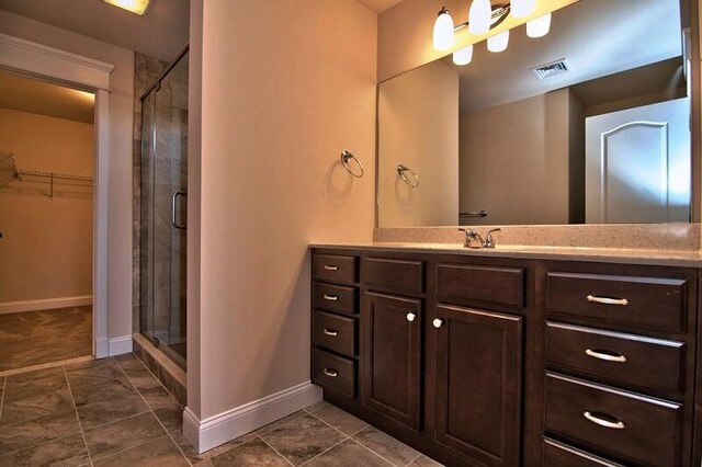 411 Pierce Ln, East Stroudsburg, PA 18301 - bathroom featuring a stall shower, vanity, a spacious closet, baseboards, and tile patterned flooring