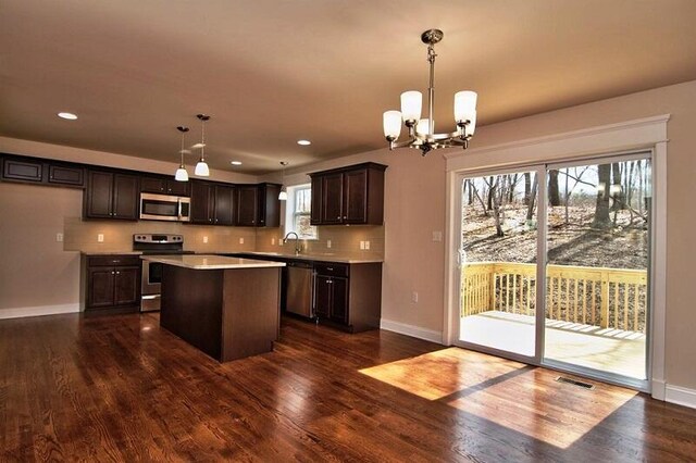 411 Pierce Ln, East Stroudsburg, PA 18301 - kitchen featuring appliances with stainless steel finishes, dark brown cabinets, baseboards, a kitchen island, and recessed lighting