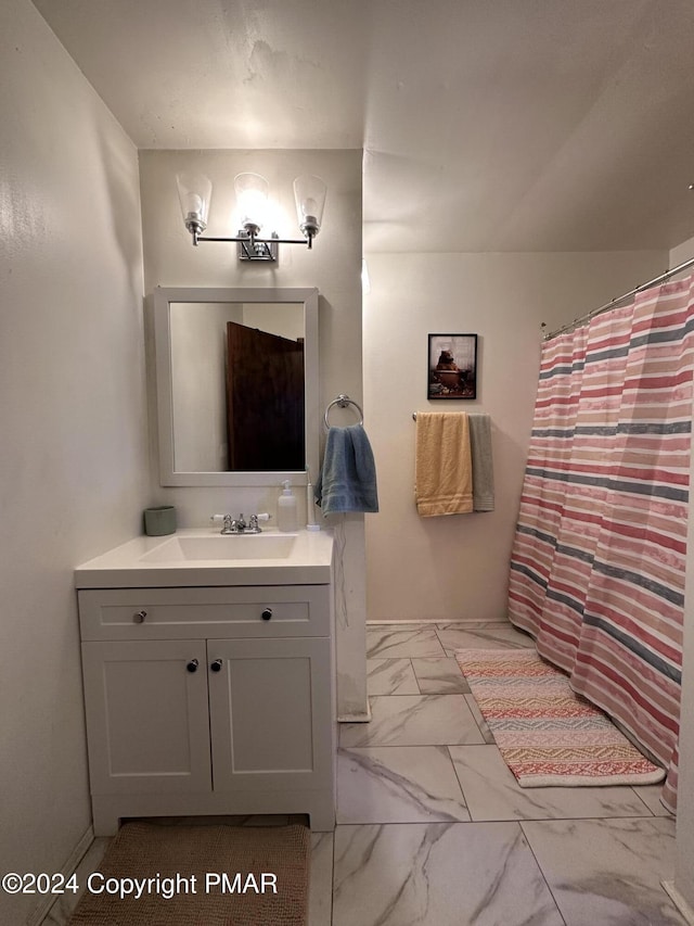 full bathroom featuring a shower with curtain, marble finish floor, and vanity