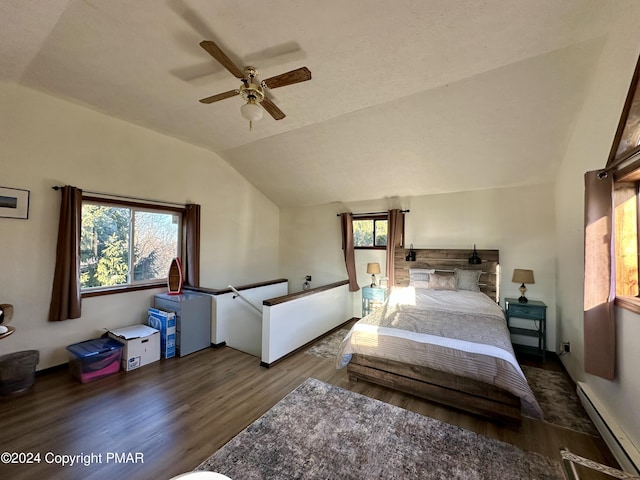 bedroom featuring a ceiling fan, lofted ceiling, baseboard heating, and wood finished floors