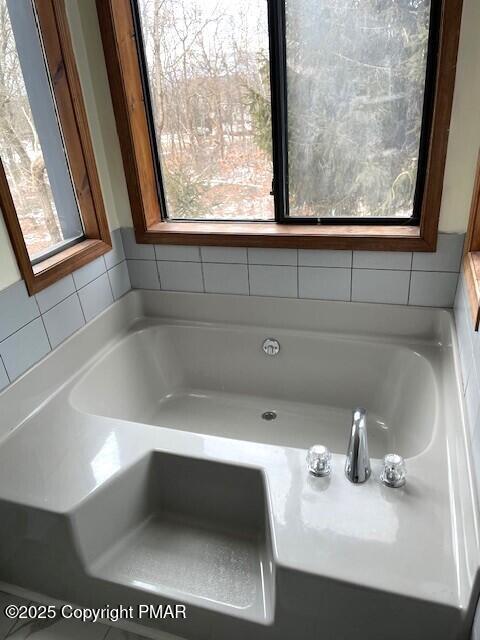 full bath with a garden tub