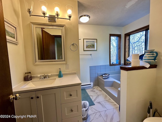 bathroom featuring a textured ceiling, a garden tub, vanity, marble finish floor, and baseboard heating