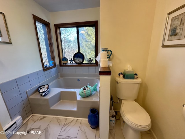 full bath with toilet, a garden tub, a baseboard heating unit, and marble finish floor