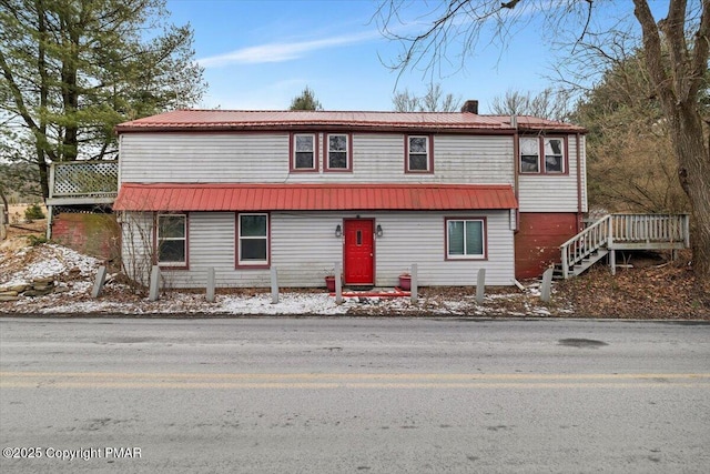 view of front of home featuring a chimney and metal roof