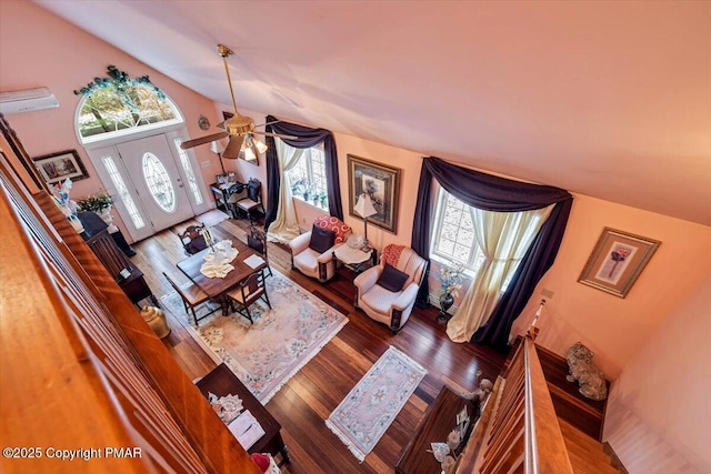 living area with lofted ceiling and wood finished floors