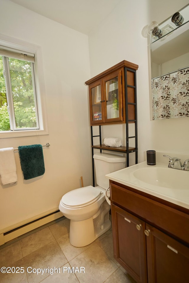 bathroom featuring a baseboard heating unit, vanity, toilet, and tile patterned floors