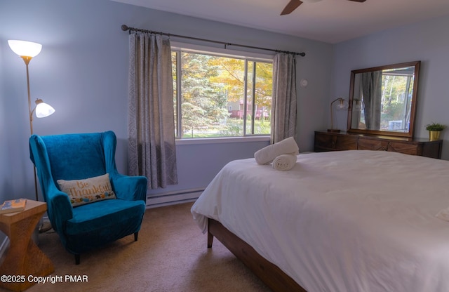 bedroom featuring a ceiling fan, carpet flooring, and baseboard heating