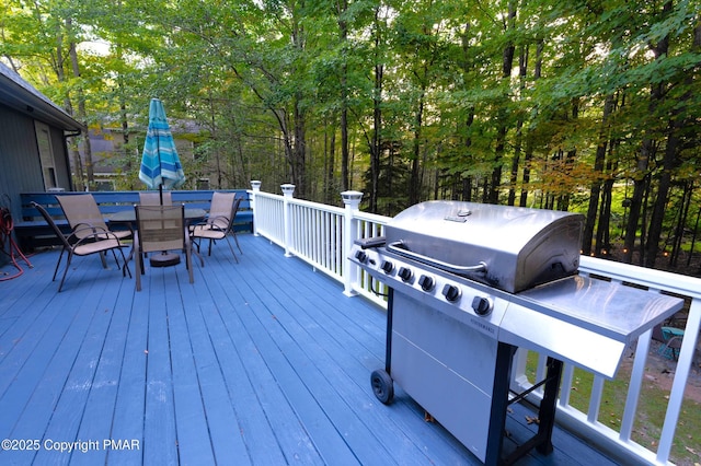 deck featuring outdoor dining area and area for grilling