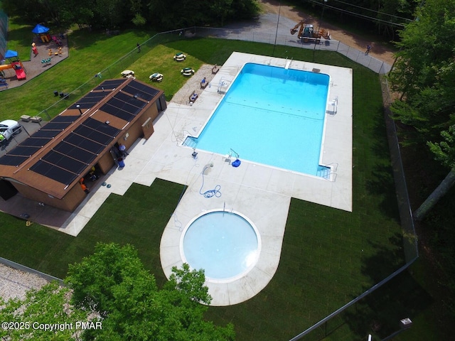 pool with a patio area, a yard, and fence