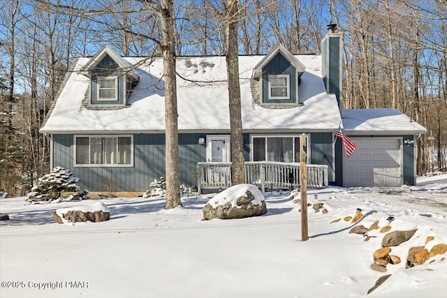 view of front of home featuring a garage, a chimney, and covered porch