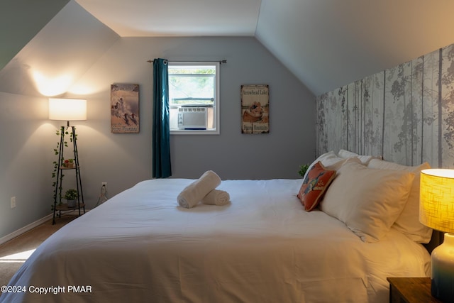 carpeted bedroom featuring vaulted ceiling and baseboards