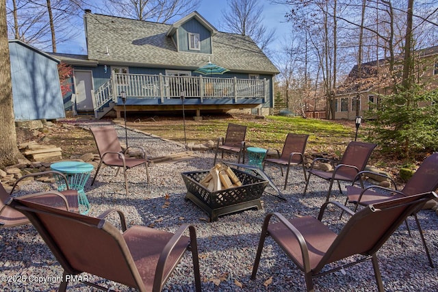 view of patio / terrace featuring a fire pit and a wooden deck