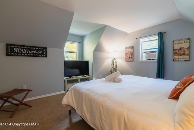 bedroom featuring carpet, multiple windows, vaulted ceiling, and cooling unit