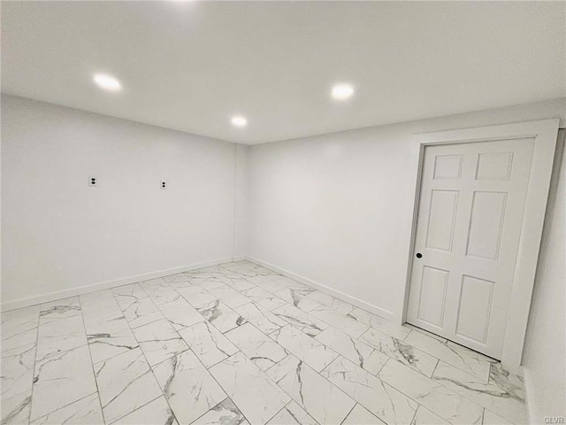 spare room with recessed lighting, baseboards, and marble finish floor