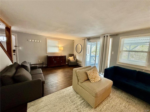 living area featuring a textured ceiling and wood finished floors